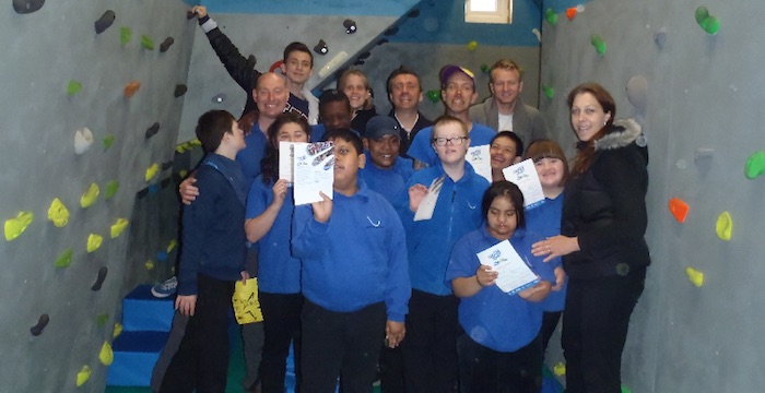 Proud school group at indoor climbing wall