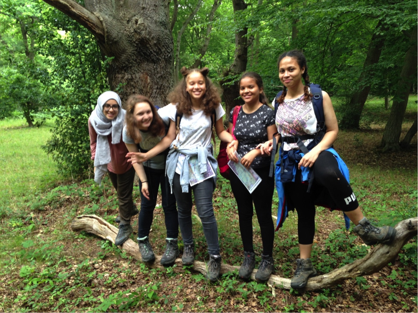 Duke of Edinburgh group smile and stand on a log together